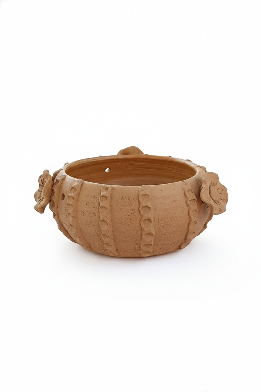 Terracotta pot with decorative handles on a white background
