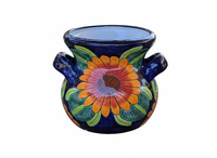Decorative ceramic pot with floral design on a white background