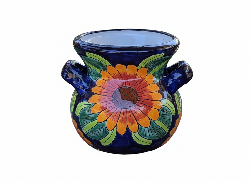 Decorative ceramic pot with floral design on a white background