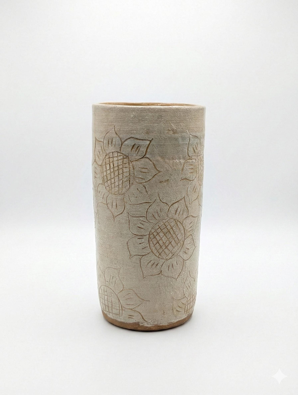 Ceramic tumbler with sunflower design on a white background