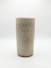 Ceramic tumbler with sunflower design on a white background