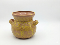 Decorative ceramic vase with a textured pattern on a white background