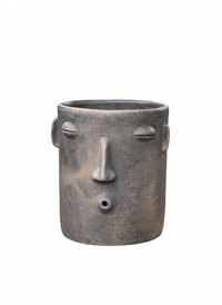 Cylindrical pot with face design on a white background