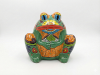 Colorful ceramic frog planter on a white background
