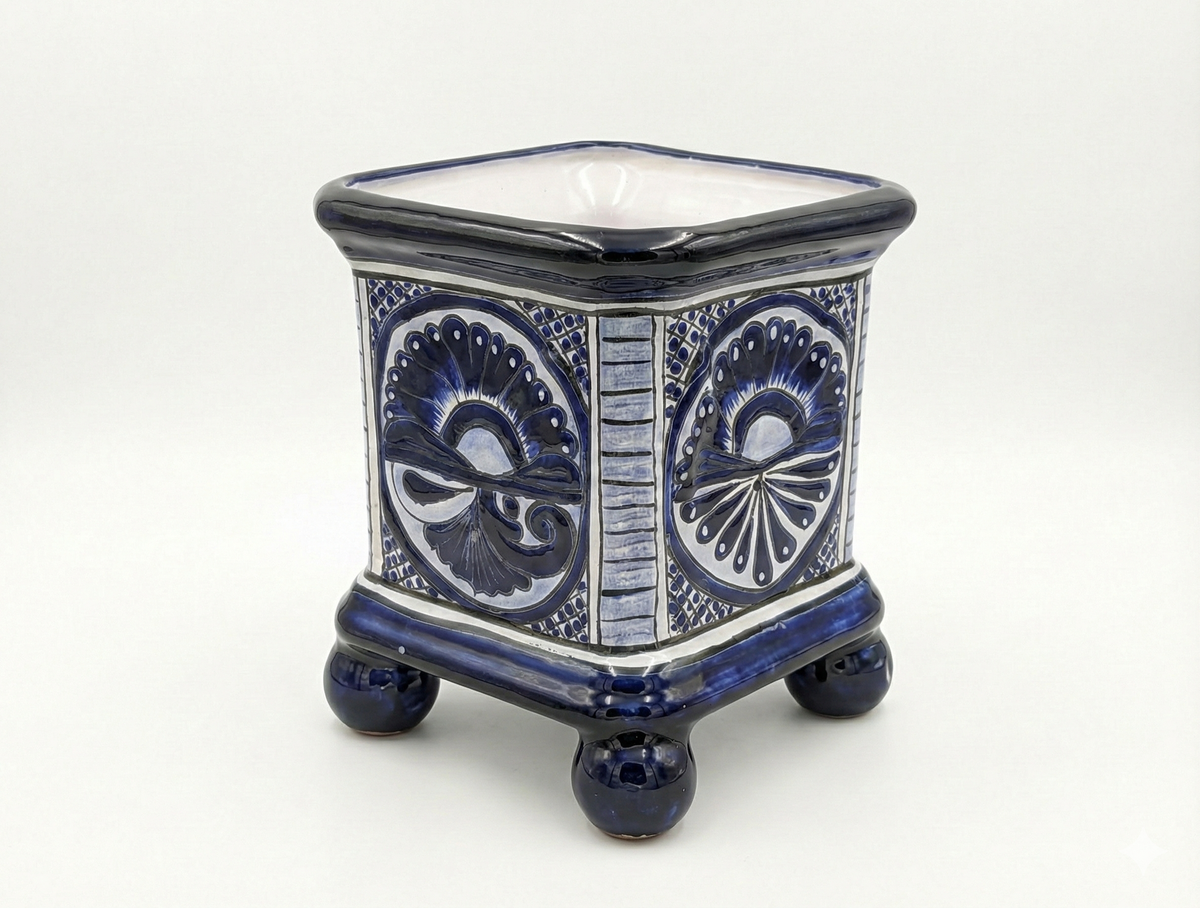 Ceramic planter with blue and white decorative patterns on a white background