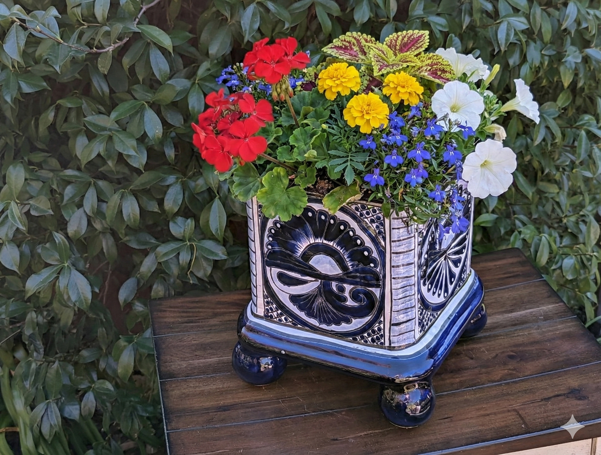 Decorative flower pot with colorful flowers on a wooden surface